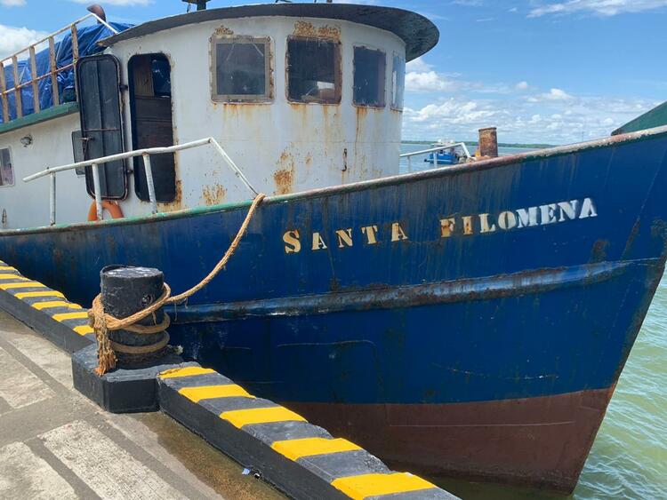A boat on the water, named Santa Filomena