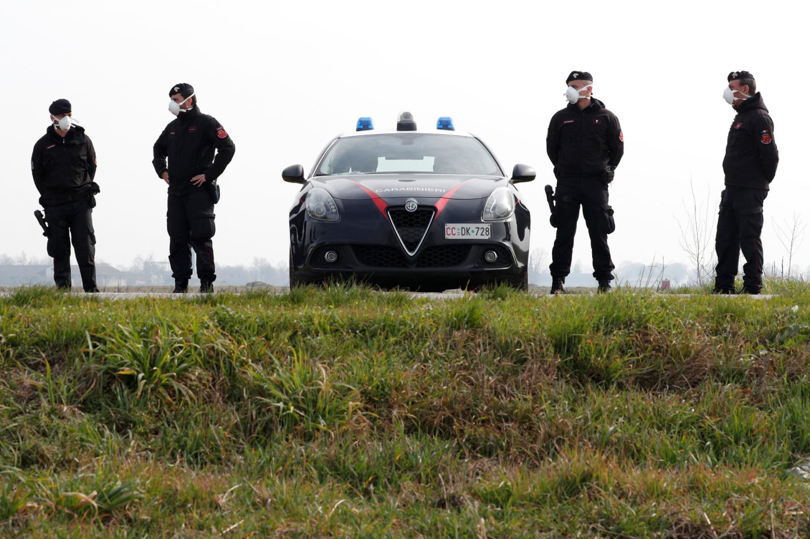 Carabinieri officers patrol outside the town of Castiglione D'Adda, which has been closed by the Italian government due to a coronavirus outbreak, Italy, February 23, 2020. REUTERS/Guglielmo Mangiapane