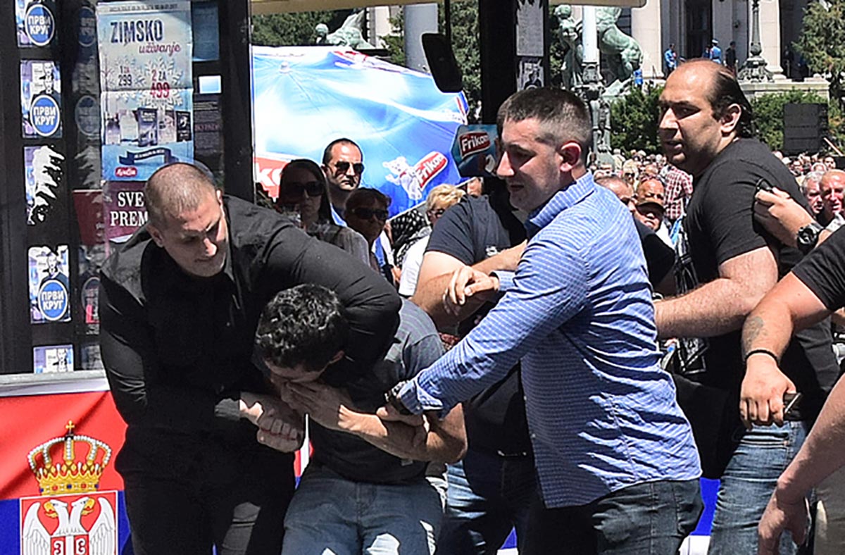 A man identified as Borko Aranitovic assaults a protester during the new Serbian president's inauguration ceremony on June 23. (Photo: E-stock.us/Aleksandar Bačlija)