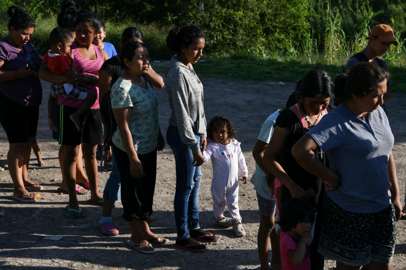 Migrants, most of them asylum seekers sent back to Mexico from the U.S. under the "Remain in Mexico" program officially named Migrant Protection Protocols (MPP), wait in line to receive bottles of drinking water by a makeshift encampment in Matamoros, Tamaulipas, Mexico, October 28, 2019. REUTERS/Loren Elliott