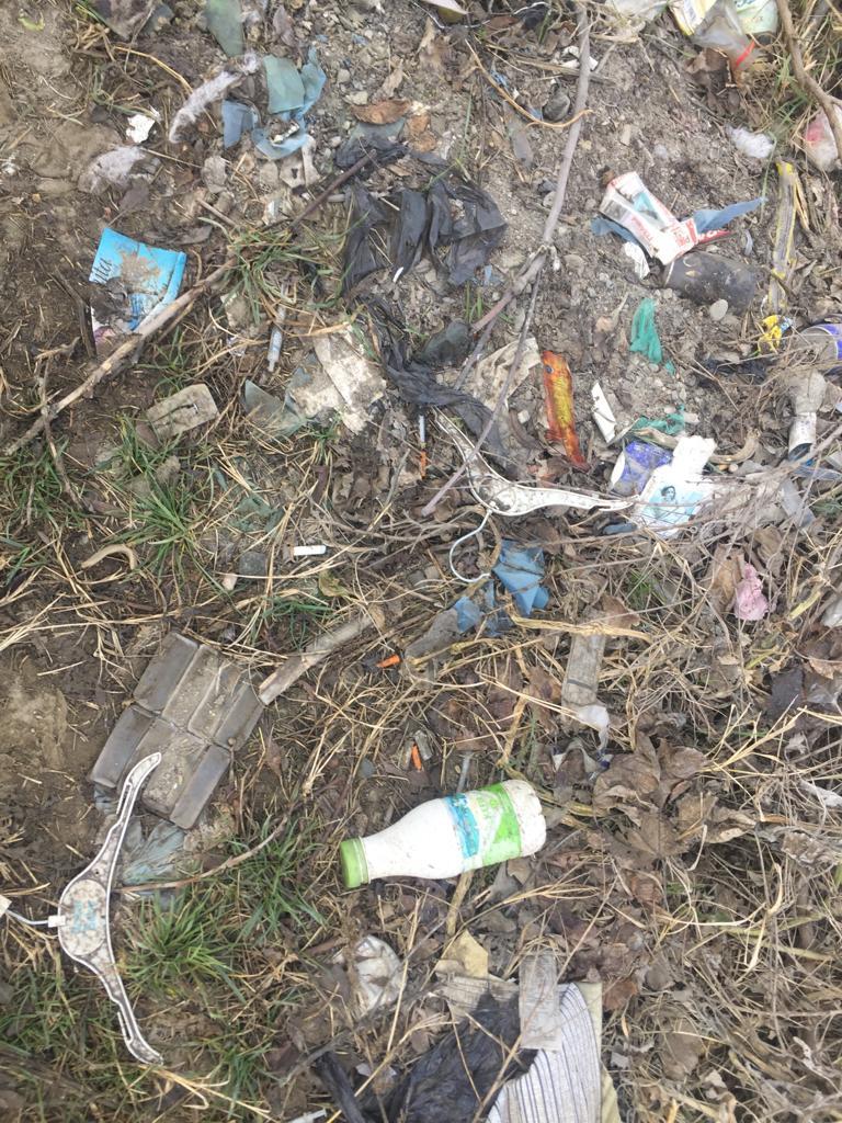 Syringes and other detritus in Lower Ponichala’s graveyard. (Credit: Ulviyya Aliyeva)