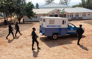 Rwandan police guard the van carrying Paul Rusesabagina