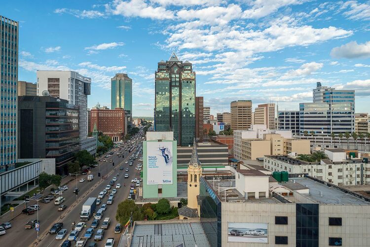 Harare city with cars driving past the Century Towers