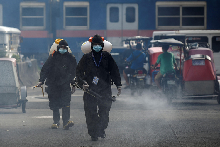 Workers disinfect streets in the Philippines