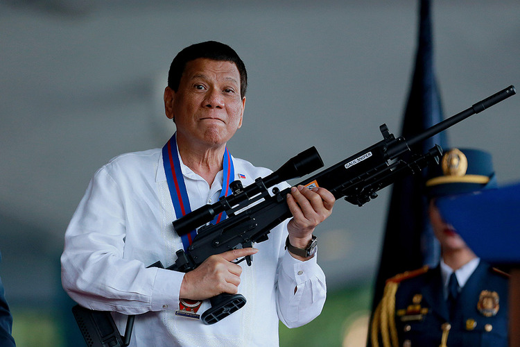 Philippine President Rodrigo Duterte holds a Galil sniper rifle