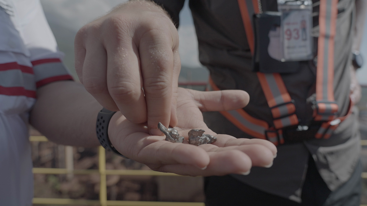 Two people hold Ferronnickel from the mine