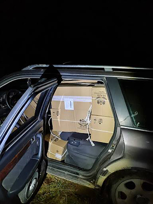 A opened car full of boxes of cigarettes