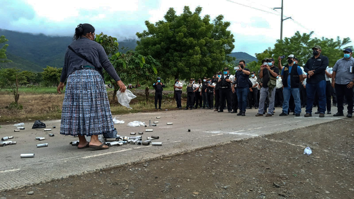 A protester surrounded by gas canisters