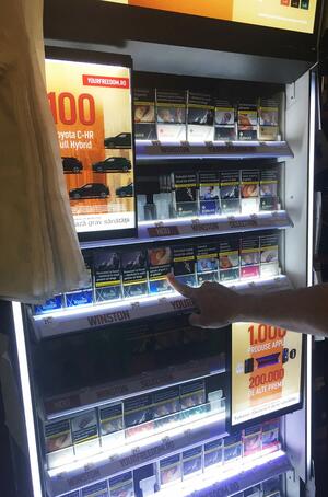 Cristian points to new JTI products at his tobacco shop
