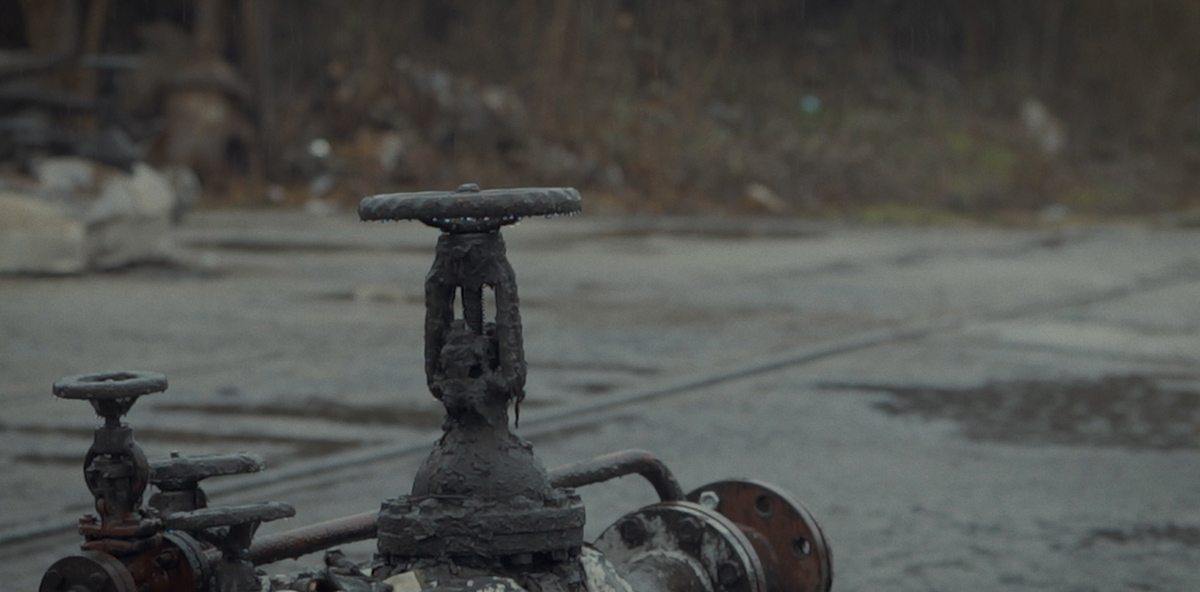 A group of weathered oil pipes.