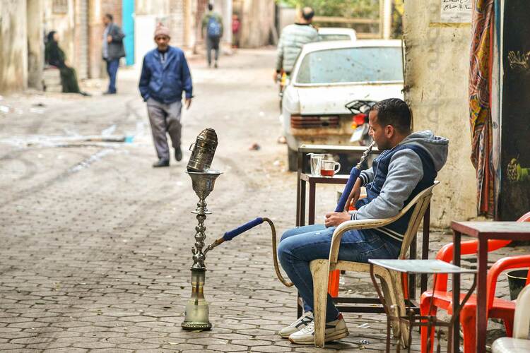 A Egypt resident sat outside smoking