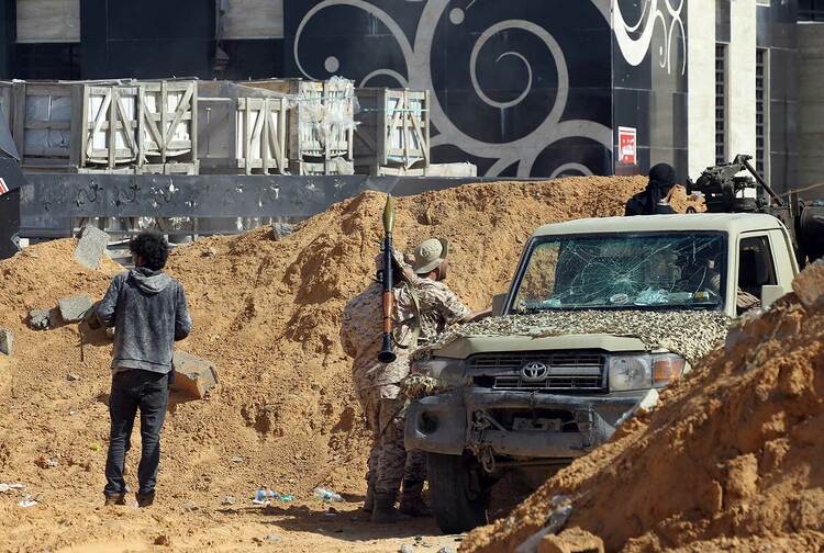 Libyan fighters clash with forces