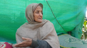 Parveen Akhtar seen sitting beneath a tarp