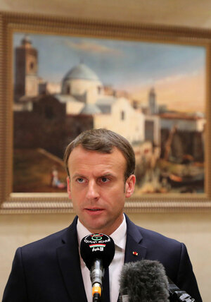 President Emmanuel Macron speaks into a microphone