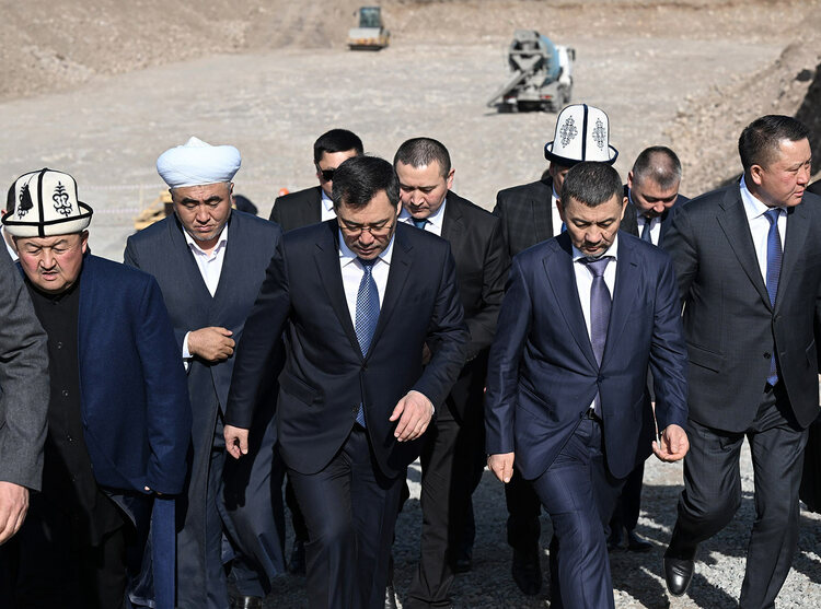 Kyrgyzstan’s President Sadyr Japarov walks with Khabibula Abdukadyr