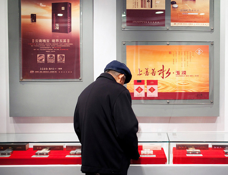 Man looks at display cases in a museum