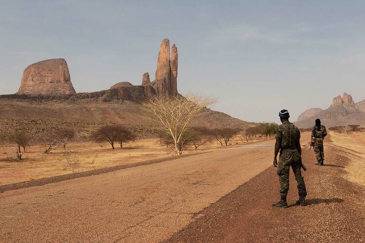 Malian soldiers patrol the roads