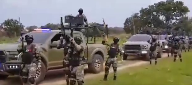Dozens of the CJNG’s members appear beside armored vehicles, holding automatic weapons and wearing military gear sporting the group’s insignia.