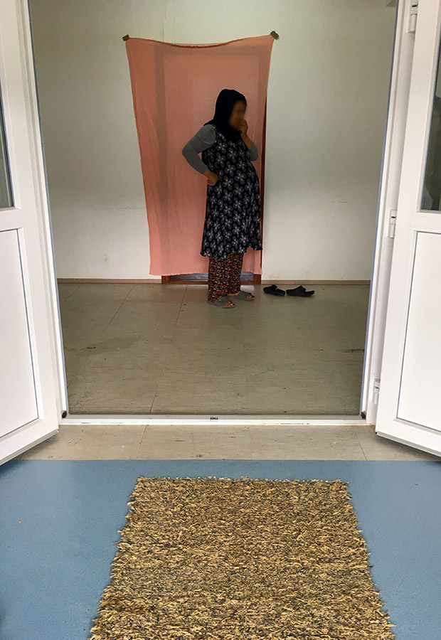 Ali’s wife standing in front of her room in the Salakovac refugee center in Bosnia.