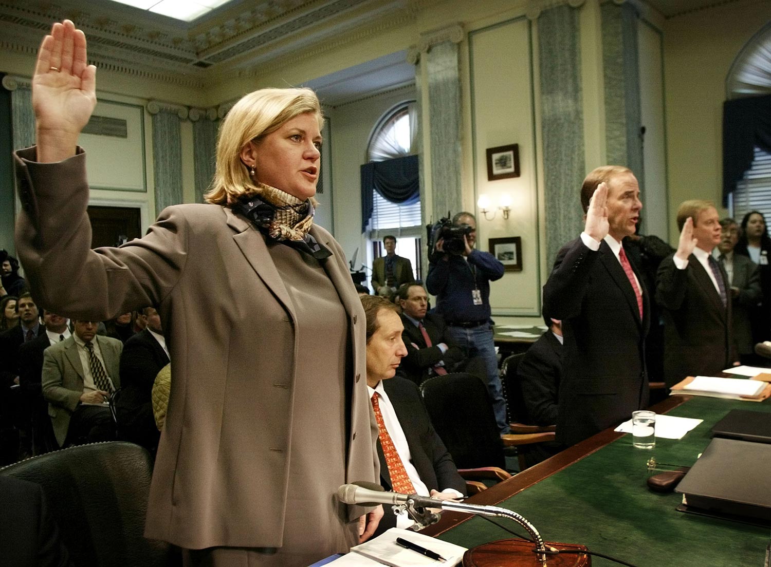 The woman who brought down Enron, Sherron Watkins, is sworn in before giving her testimony to U.S. lawmakers. (Credit: REUTERS/Win McNamee)