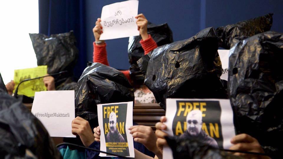 Journalists and activists demonstrate inside the Georgian Parliament building by putting bags over their heads. Mukhtarli says his kidnappers pulled a bag over his head as they were driving him to Azerbaijan. (Photo: Tornike Mandaria/On.ge)