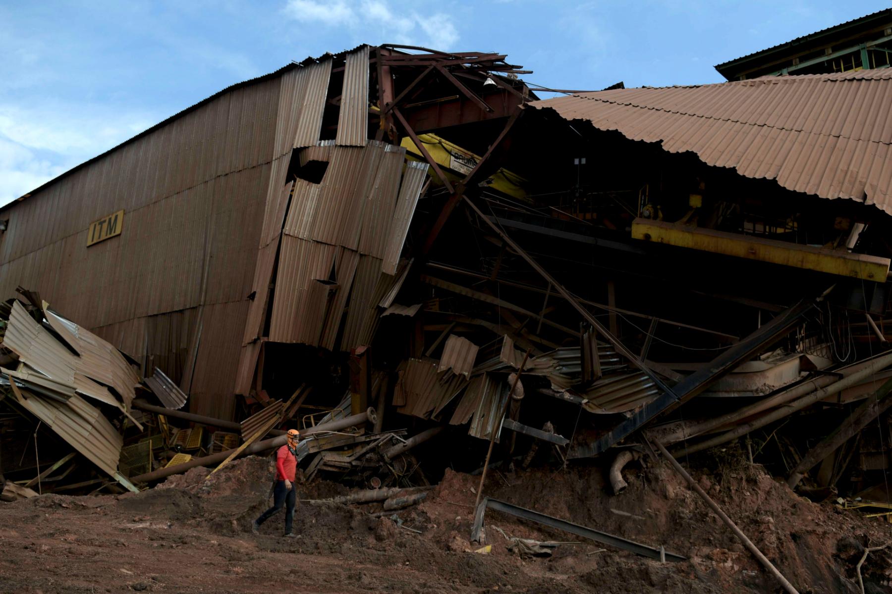A member of a rescue team walks next to a collapsed tailings dam owned by Brazilian mining company Vale in Brumadinho, Brazil, Feb. 13, 2019. 